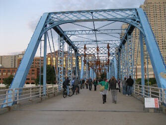 Metal monkeys hanging from the Blue Bridge in Grand Rapids.
